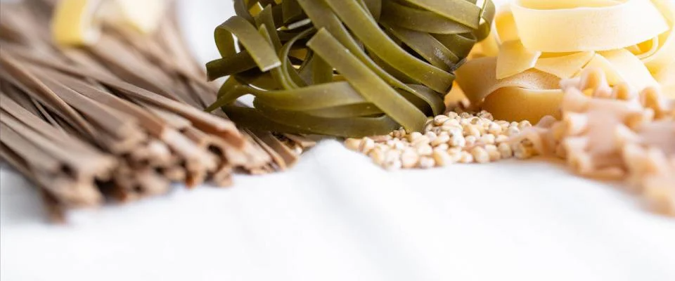 Ancient grains displayed in bowls, including quinoa, barley, and millet