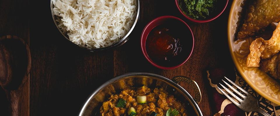 A selection of meals including rice, grilled chicken, and mixed vegetables arranged attractively on a serving platter.