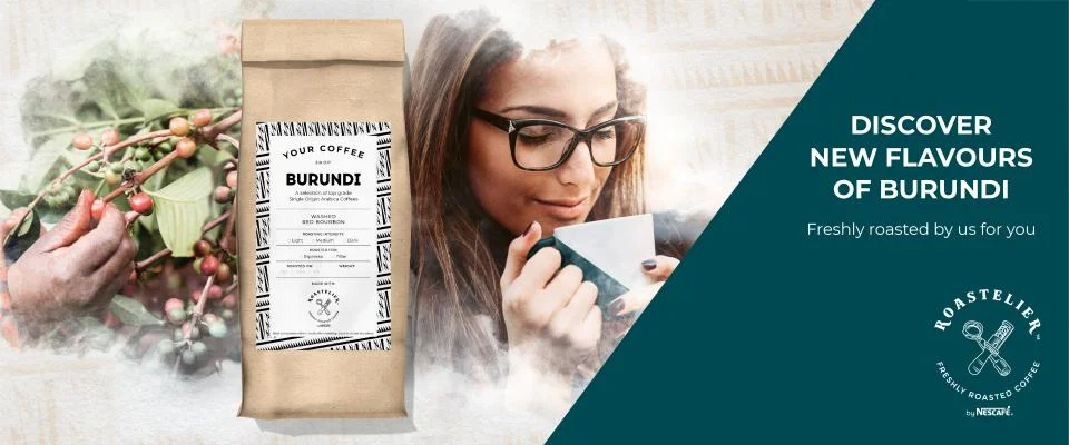 A woman enjoys a cup of coffee beside a bag of Burundi Coffee, freshly roasted and flavorful.