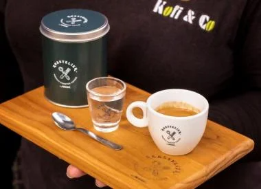 Tray featuring a cup of coffee and a spoon, showcasing her hospitality and warmth.