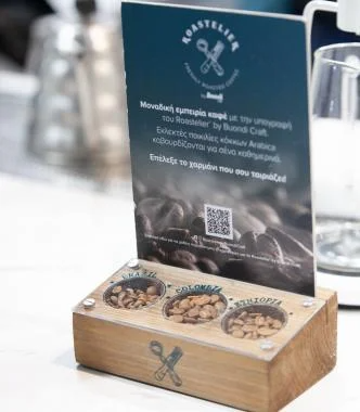 A wooden display featuring coffee beans alongside a menu showcasing various coffee options.