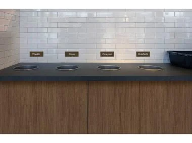 A counter featuring four sinks, each designed for efficient use, alongside an additional sink.
