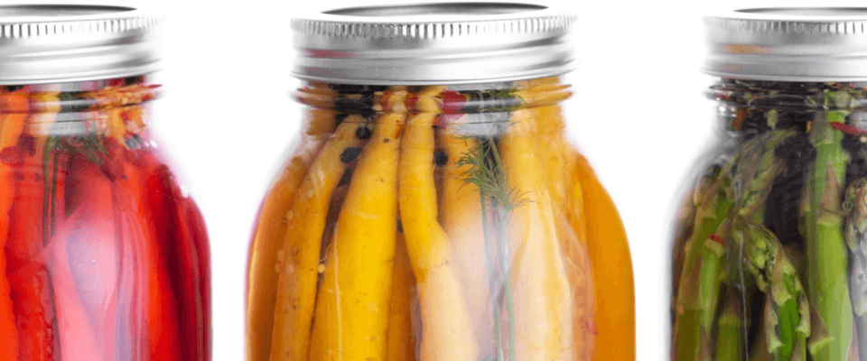 Jars filled with pickled vegetables, showcasing how to preserve the goodness of fresh produce.