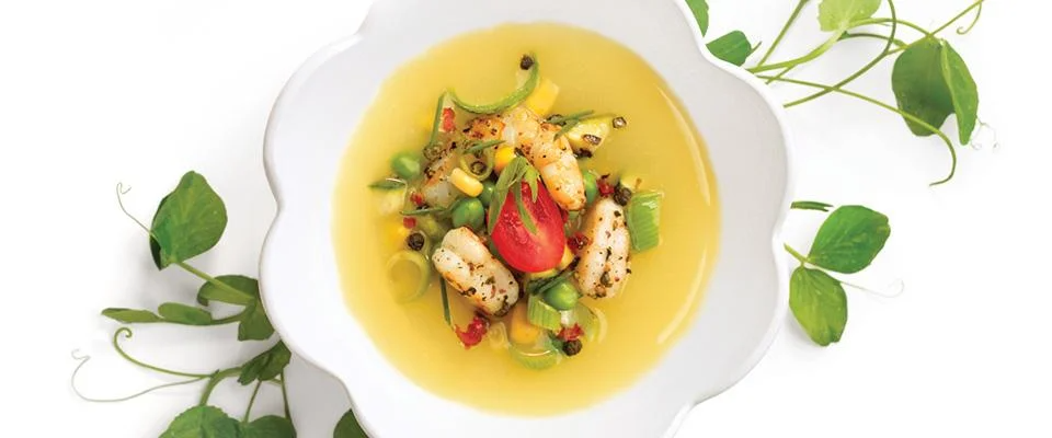 A bowl of shrimp soup with vegetables, showcasing healthy menu hacks for flavorful dishes.