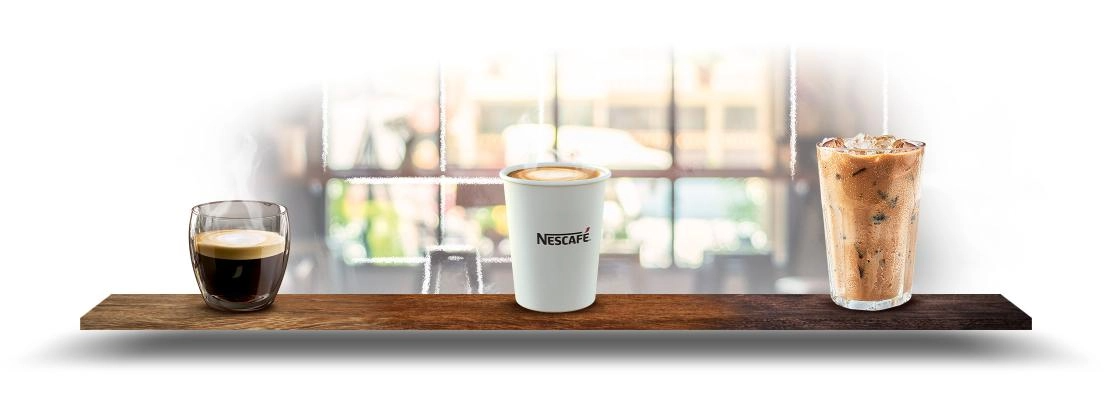 A wooden shelf with three drinks, arranged in glasses, presenting a colorful and inviting display.