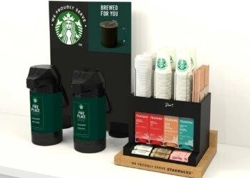 A Starbucks coffee display featuring two cups and a cup holder, showcasing a cozy coffee moment.