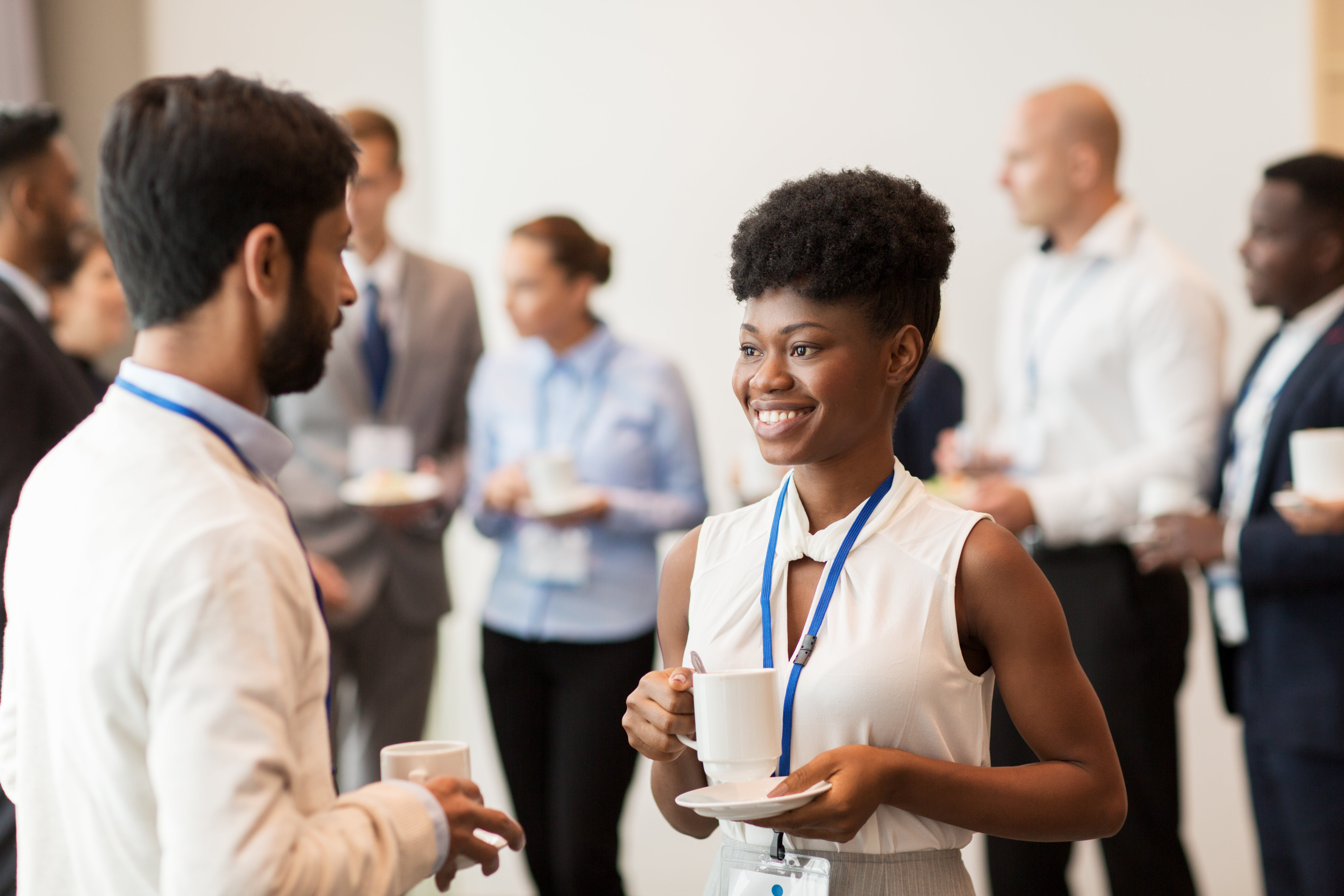 Two women discussing business topics at an event, showcasing networking.