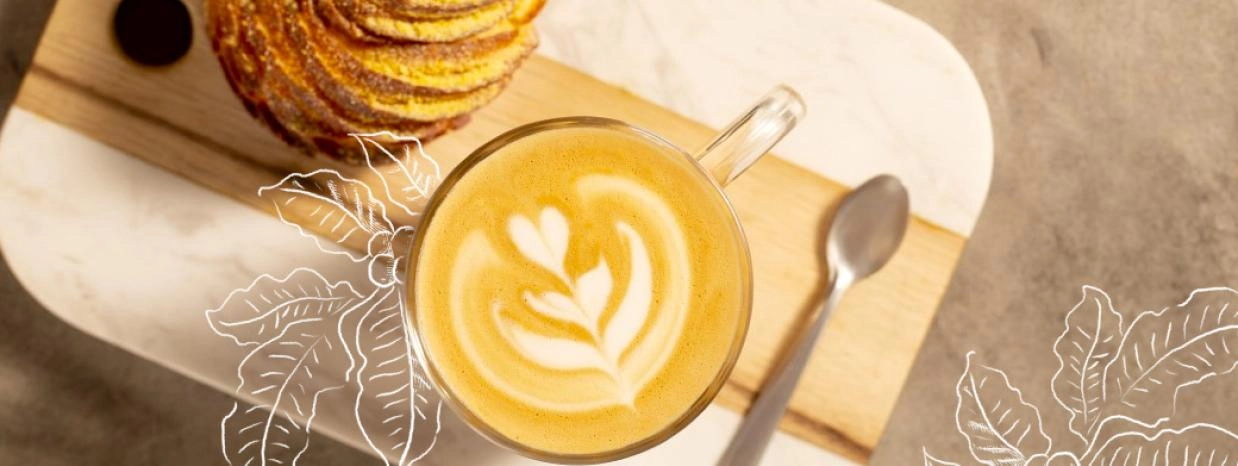 A cup of coffee featuring a beautiful swirl of white and yellow on the surface, inviting and warm.