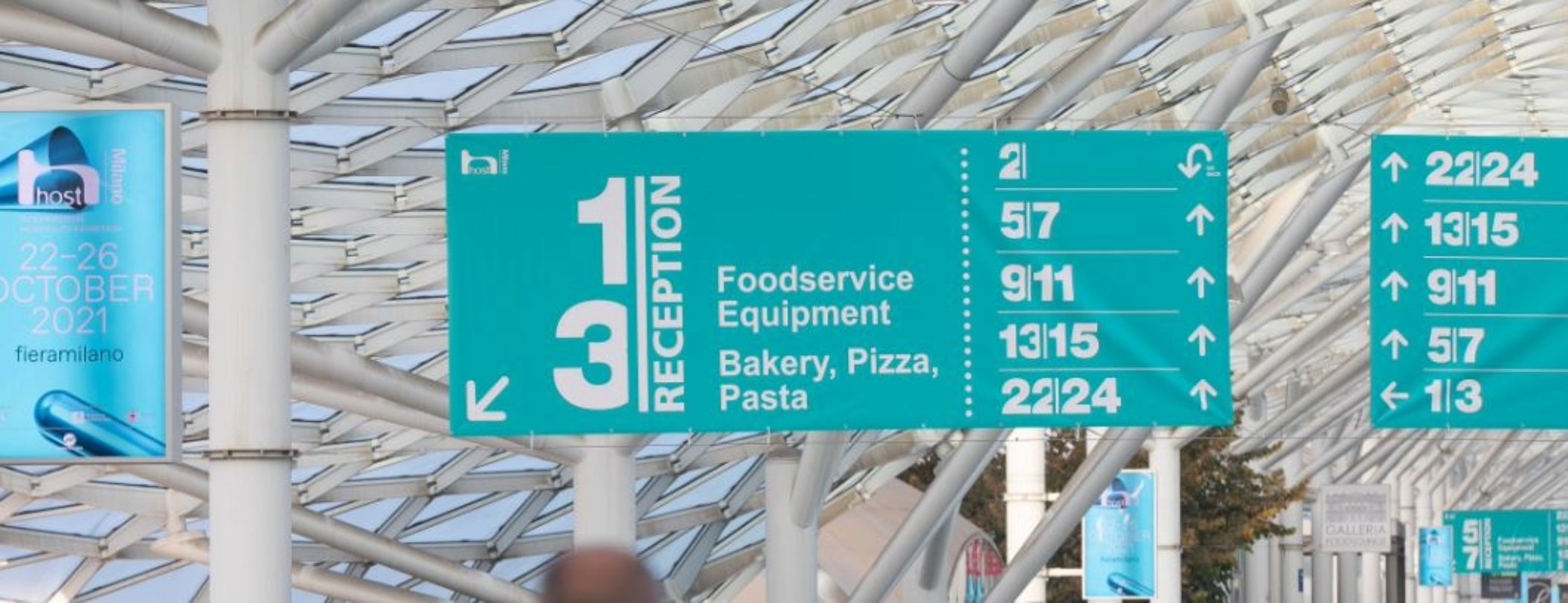 Signs at an airport help passengers navigate and find essential services and directions.