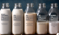 Different types of milk bottles, featuring whole, skim, and plant-based milk options.