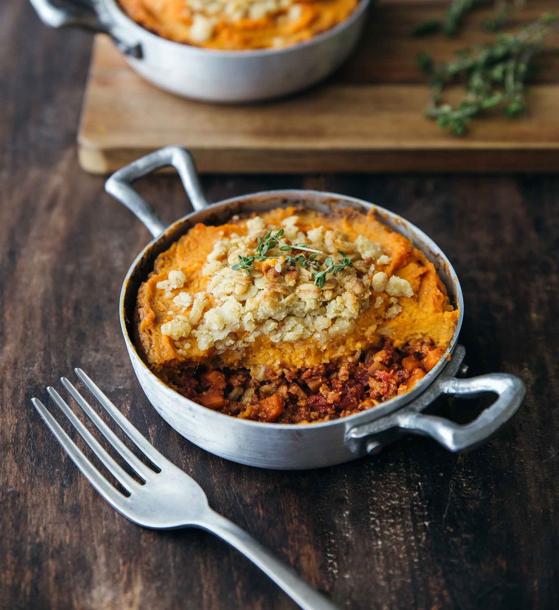 A sweet potato casserole topped with a golden crumble, showcasing an inviting dish ready to serve.