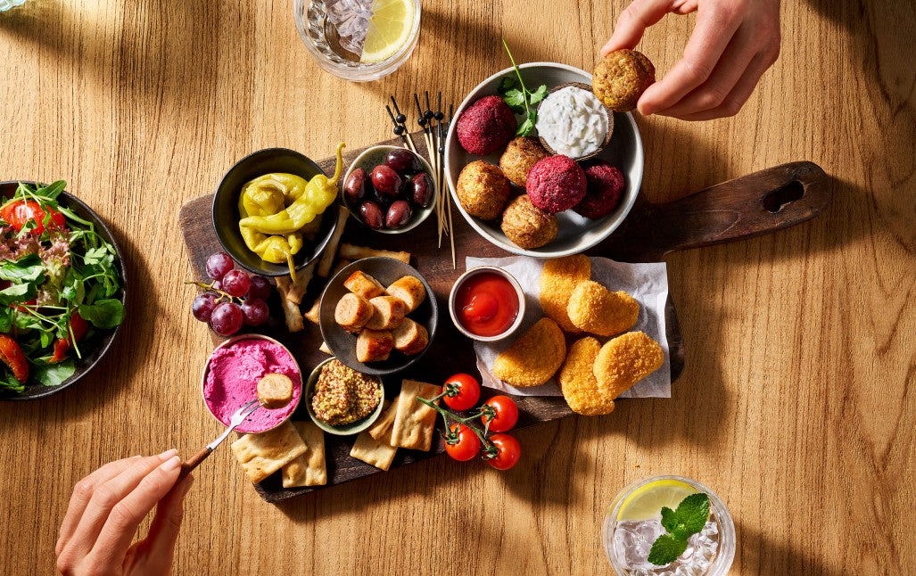 A table set with an array of food and drinks, inviting and ready for a gathering or celebration.