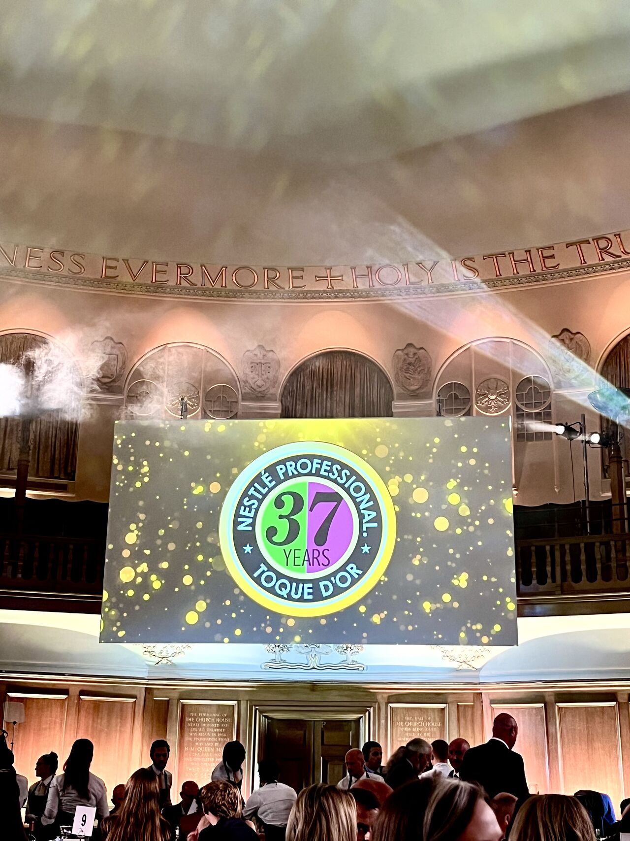 Nestlé Professional Toque d'Or 37 Years celebration with spotlight and golden confetti.