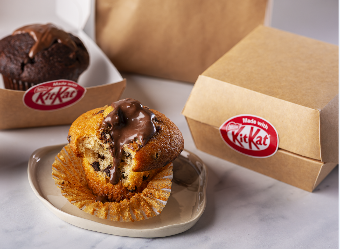 A Muffin filled in with a Kit Kat sauce freshly delivered