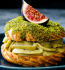 A fig and cheese sandwich elegantly presented on a blue plate.