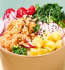 A bowl brimming with fresh vegetables and fruits, representing a healthy culinary choice.
