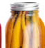 Four bottles filled with vibrant, colorful vegetables, showcasing a variety of hues and textures.