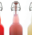 Four distinct bottles showcasing colorful liquids, creating an eye-catching arrangement.