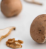 A variety of mushrooms and fresh ingredients arranged neatly on a clean white surface.