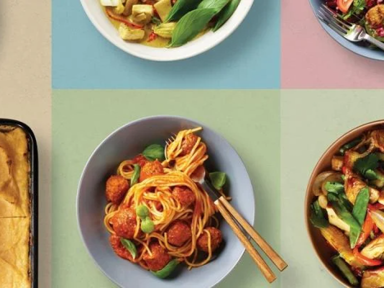 Various foods displayed on plates, showcasing different cuisines and vibrant ingredients.