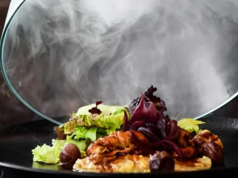 A person holds a plate filled with delicious food, ready to enjoy a meal.