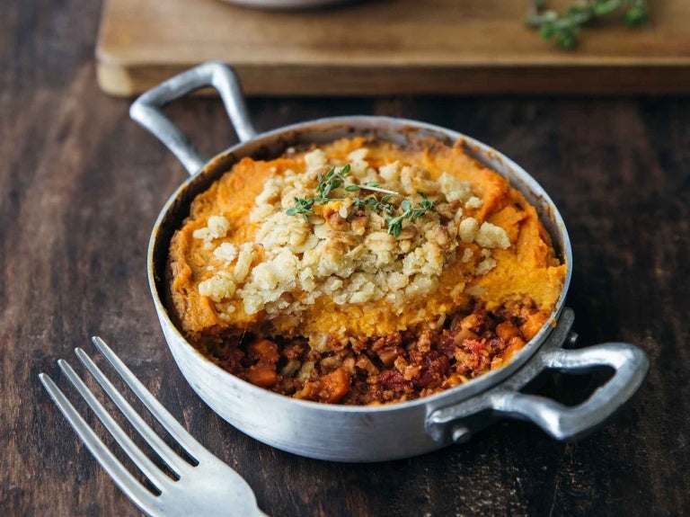 A sweet potato casserole topped with a golden crumble, showcasing an inviting dish ready to serve.