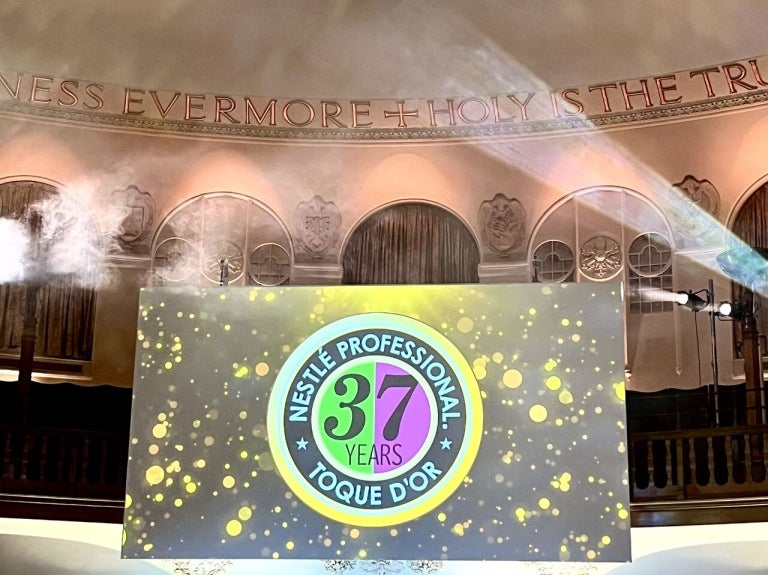 Nestlé Professional Toque d'Or 37 Years celebration with spotlight and golden confetti.