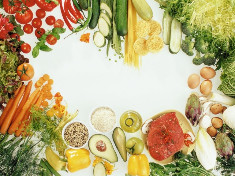 An assortment of fruits and vegetables displayed in a circle, highlighting the importance of reducing food waste.