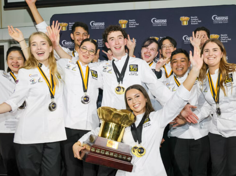 A group of chefs and students proudly display their trophy at the Nestlé Golden Chef’s Hat Award ceremony