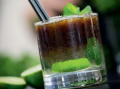 A vibrant mojito cocktail in a glass, featuring mint and lime for a refreshing summer drink.